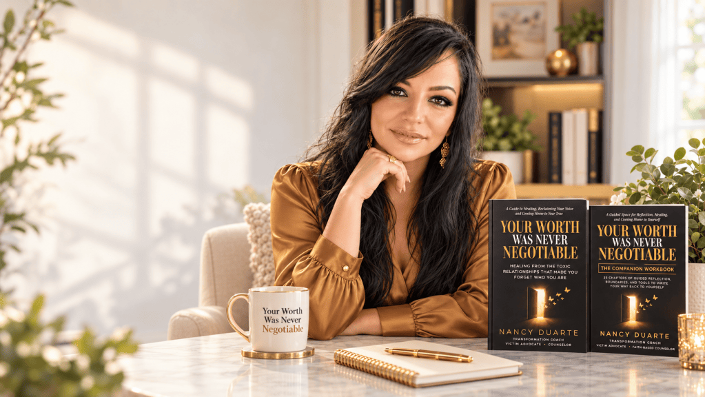 A woman sitting at a table with two books titled 'Your Worth Was Never Negotiable' by Nancy Duarte. She has long dark hair, wears a brown blouse, and is holding a cup that features the book title. The background includes plants and a well-lit room.